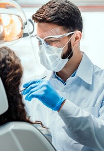 a person holding their cheek due to tooth pain