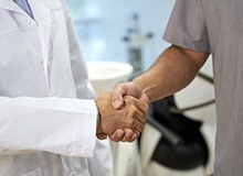 Close up of dentist and patient shaking hands